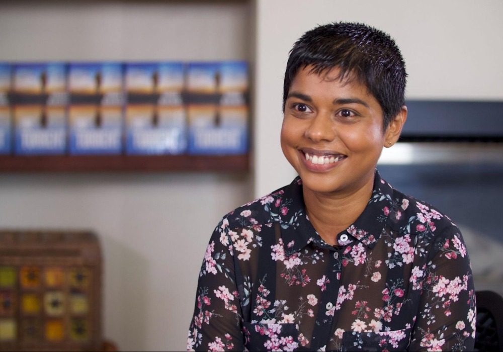 Crime fiction author and Australian Writers' Centre alumna Dinuka McKenzie smiling in floral shirt